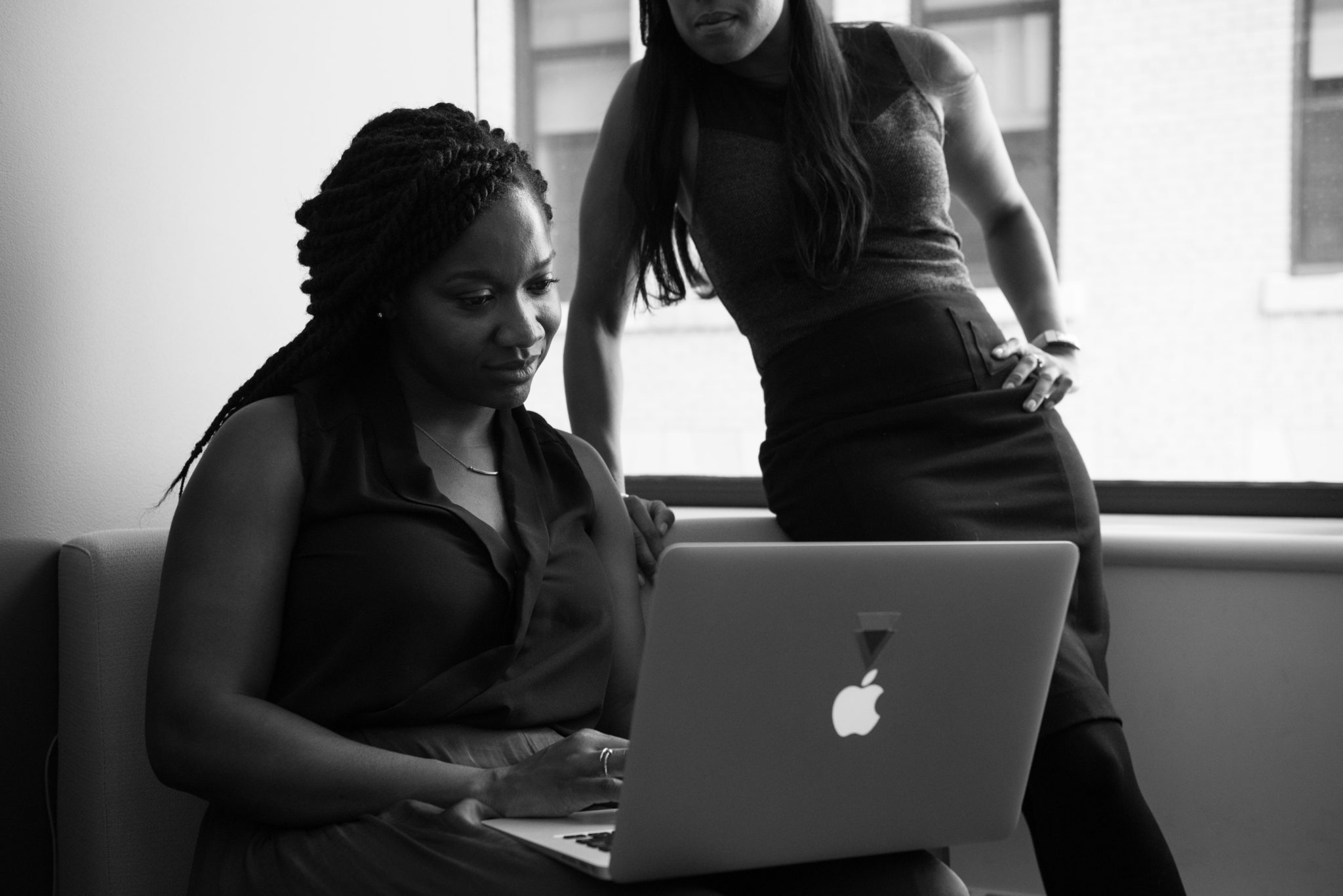 black and white image of business women looking at a laptop