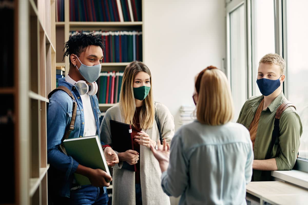 students wearing masks in a university library