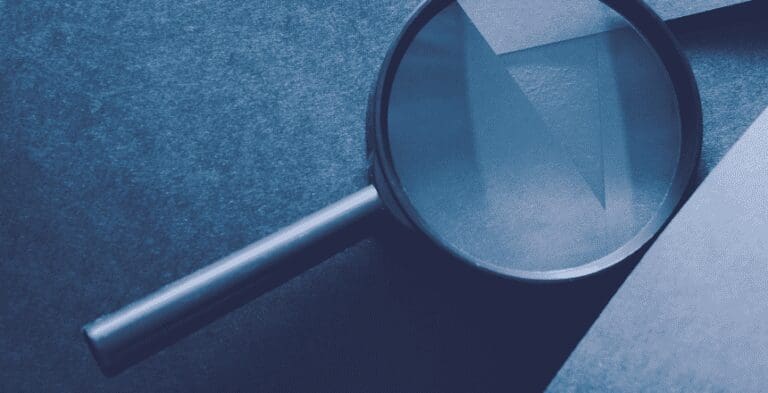 magnifying glass on blue paper