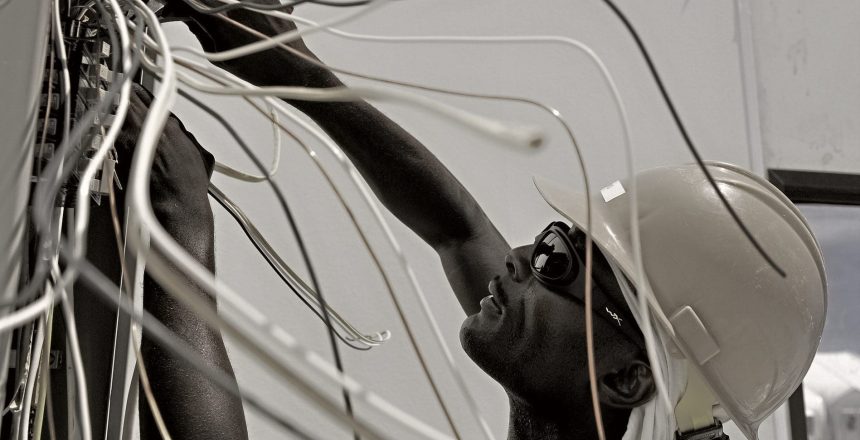 black and white image of electrician at work